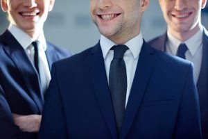 close up three smiling executives scaled 1